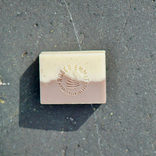 A rectangular bar of handcrafted soap with a two-tone design, featuring a cream-colored top half and a dusty rose pink bottom half. The bar is embossed with the brand name 'Rosco Emmitt' and 'Vancouver Island' with a small tree logo.